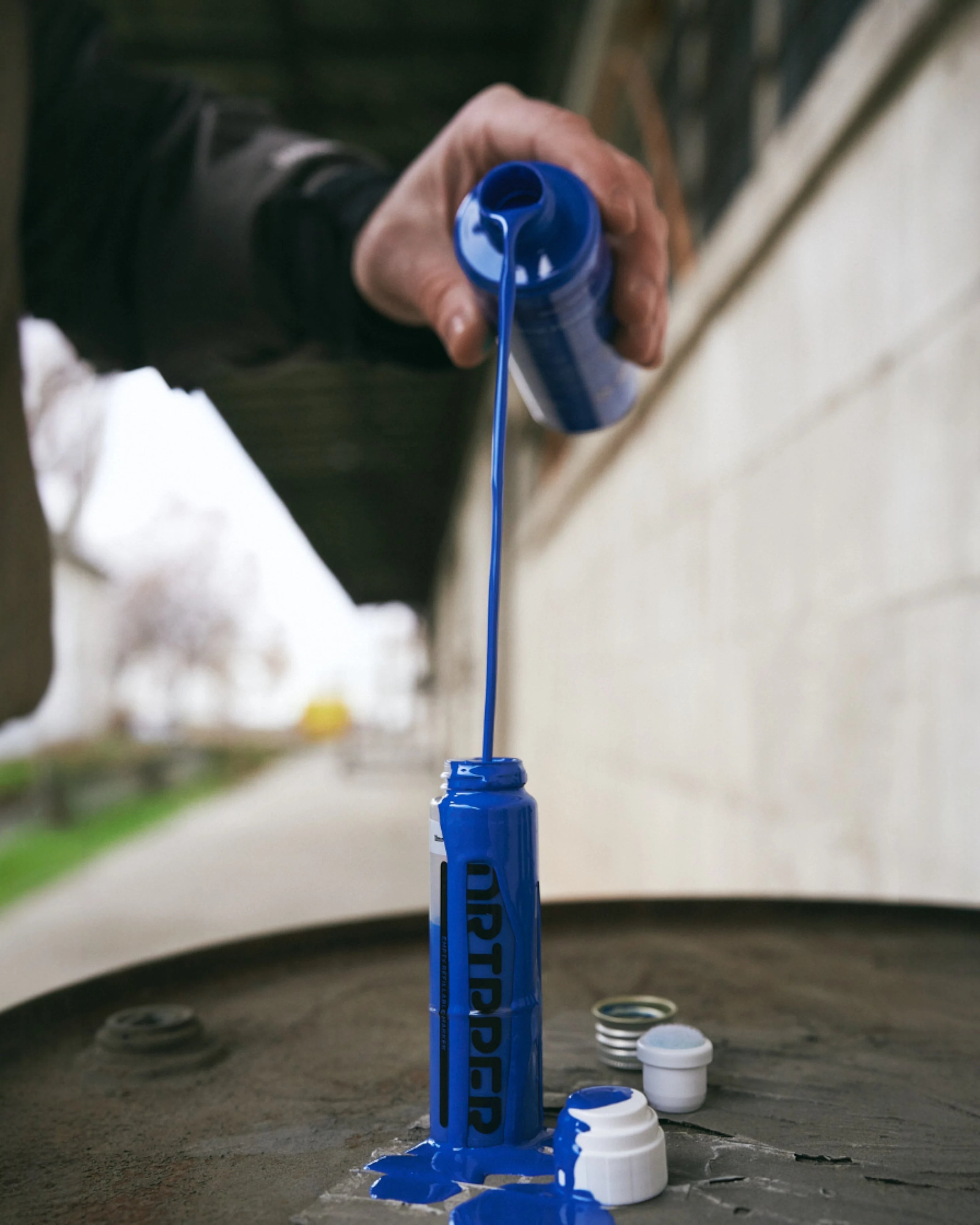 Astrofat Dope Dripper 10mm tagging marker being refilled with vibrant blue alcohol-based paint.