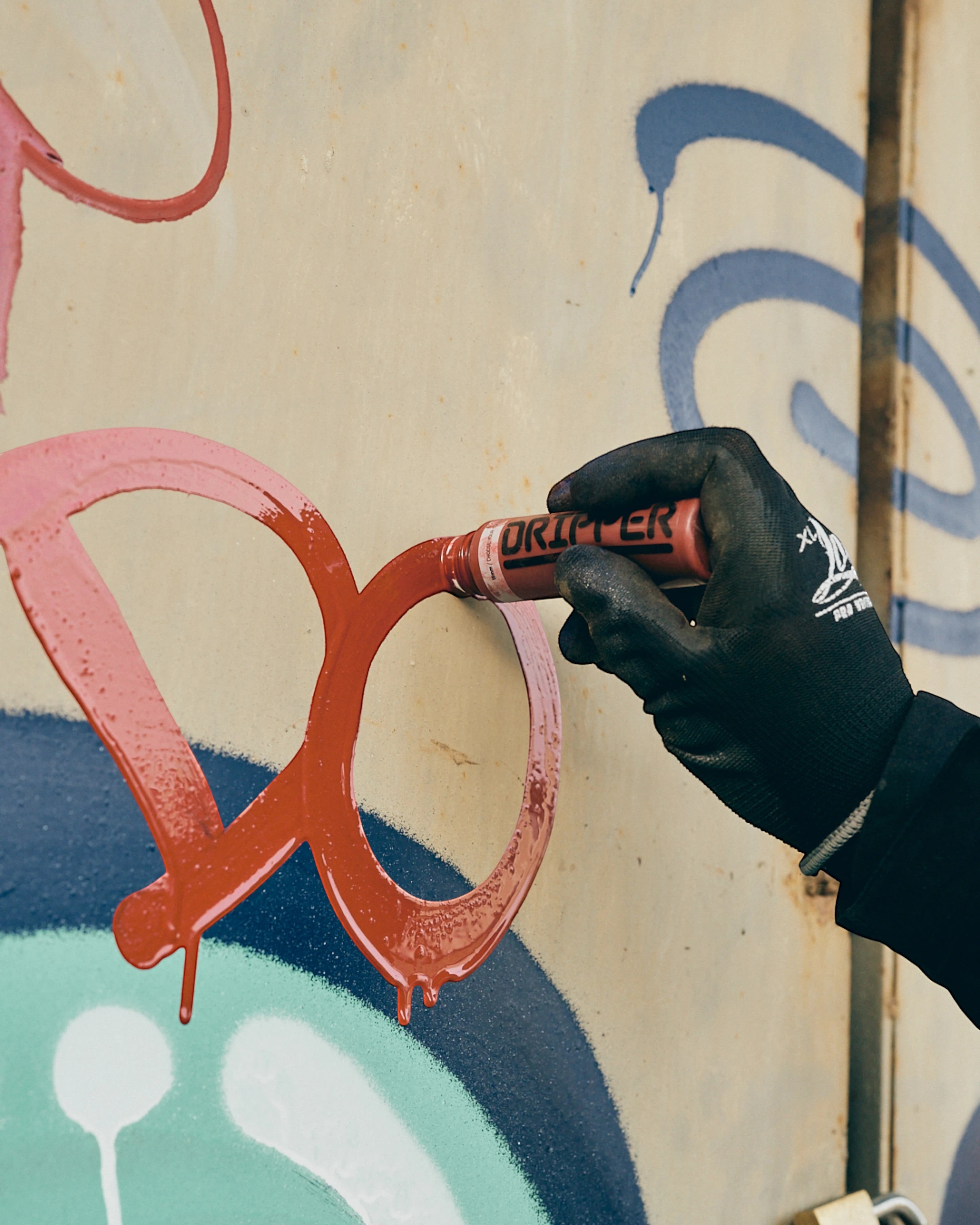 Astrofat Dope Dripper 18mm marker in red ink being used to create graffiti art on a textured surface.