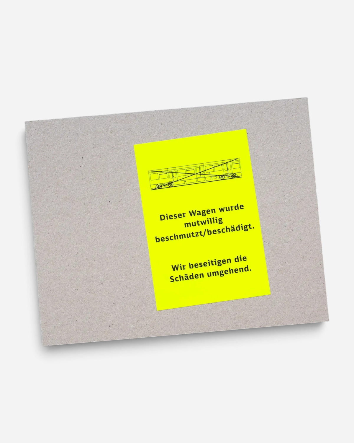 Astrofat Farbzüge hardcover book with raw cardboard cover and a bright neon yellow sticker featuring train graphics.