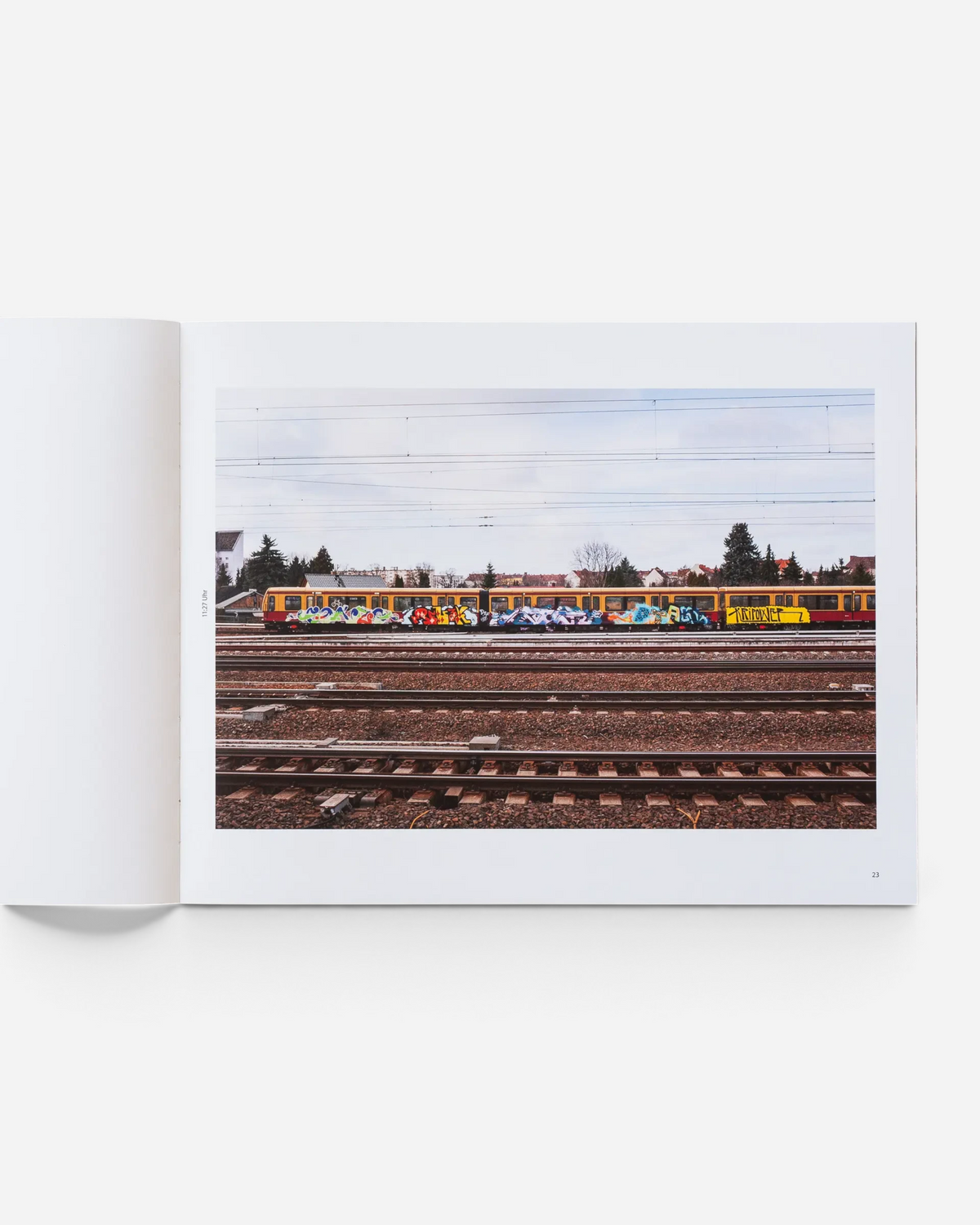 A spread from the Astrofat book Farbzüge showing a graffiti-covered Berlin train on tracks in a landscape setting.