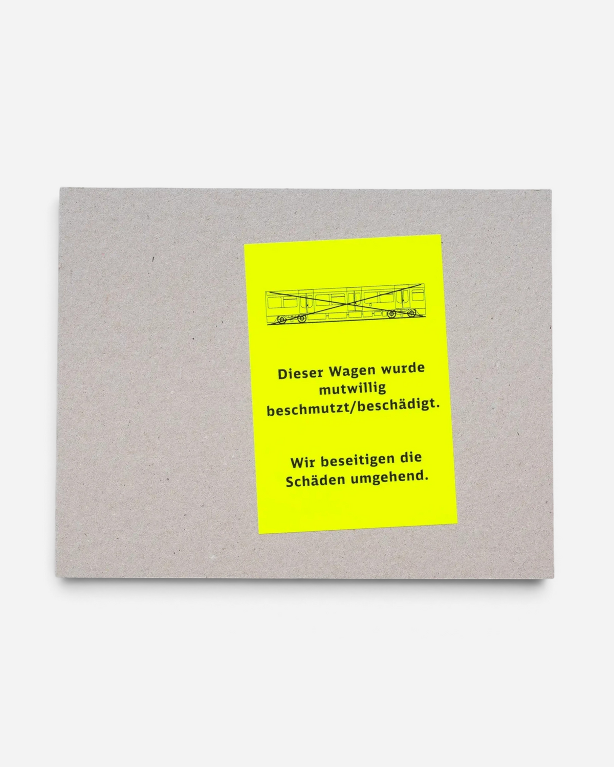 Astrofat Farbzüge photography book with a raw cardboard cover and a bright neon yellow sticker featuring train art.