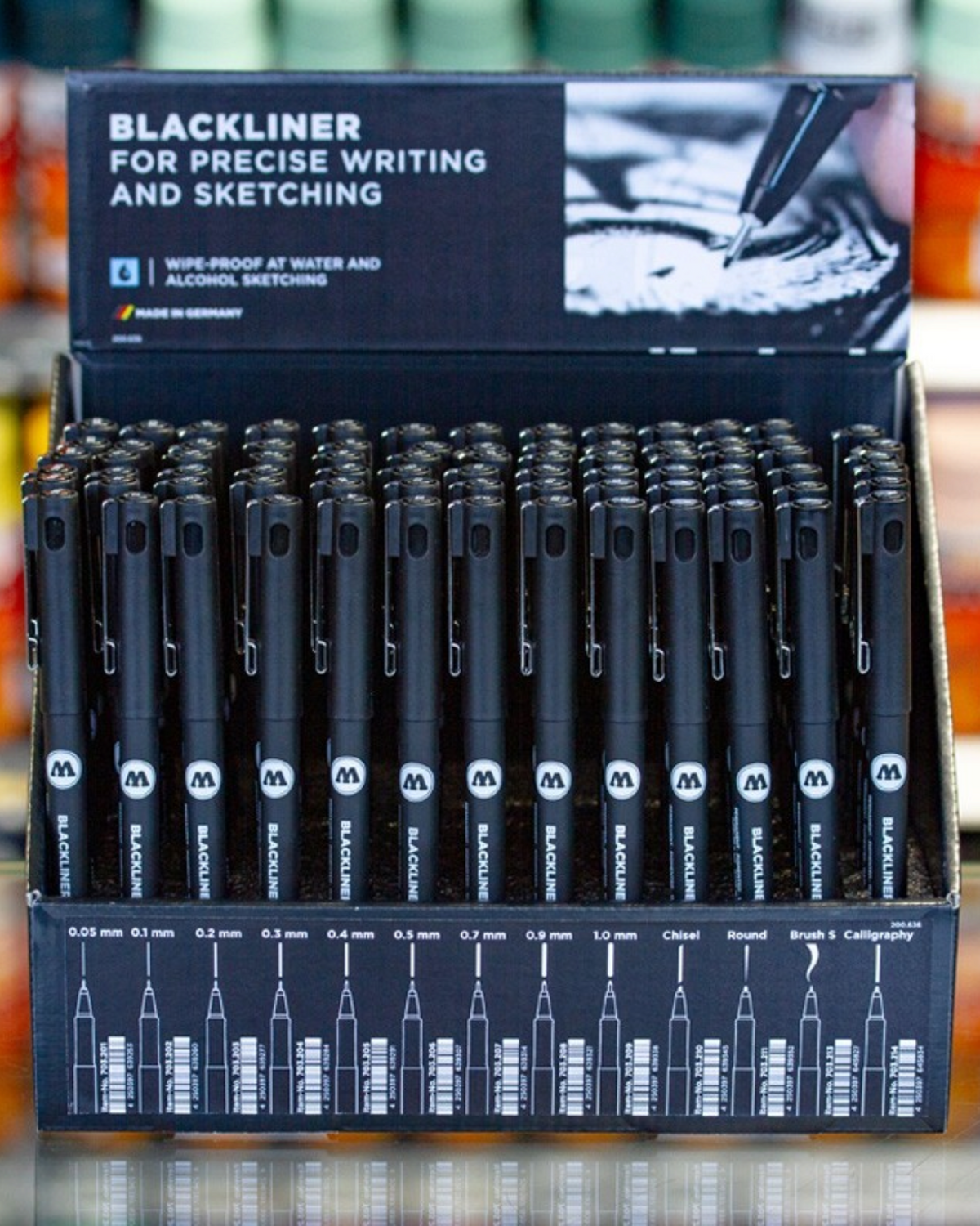 Astrofat Molotow Blackliner marker sales display containing 78 assorted black pigment ink pens for precise sketching.
