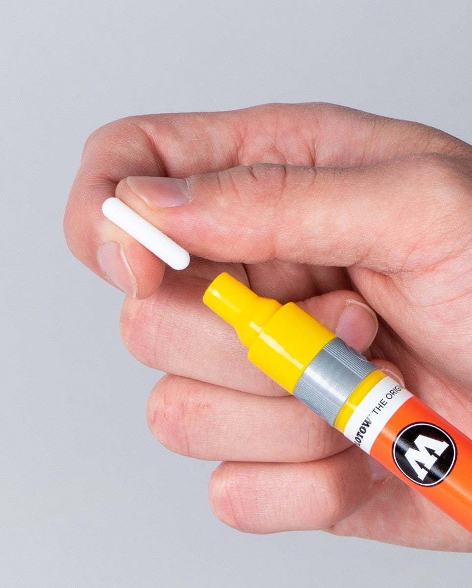 Astrofat Molotow One4All acrylic marker with a replaceable 2mm round tip being held by a hand