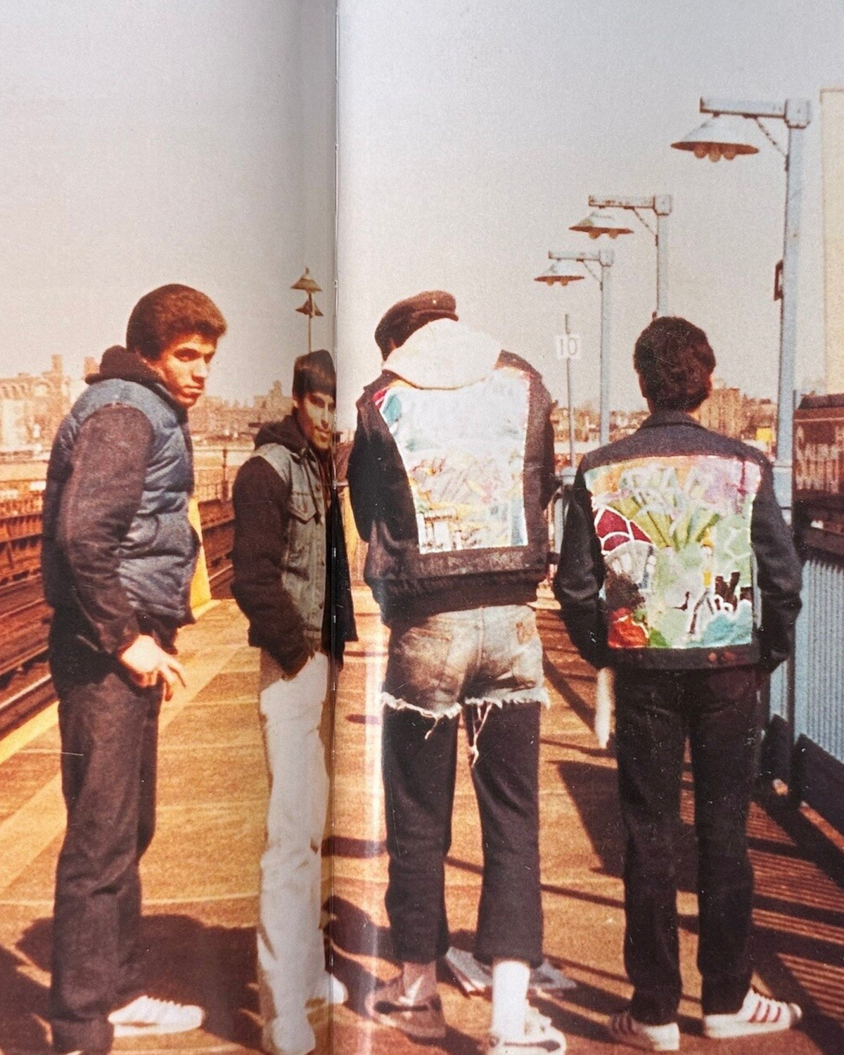 Astrofat The Nasty Terrible T-Kid 170 book cover featuring four young men in denim jackets with graffiti art on the back, standing on a subway platform in New York City.