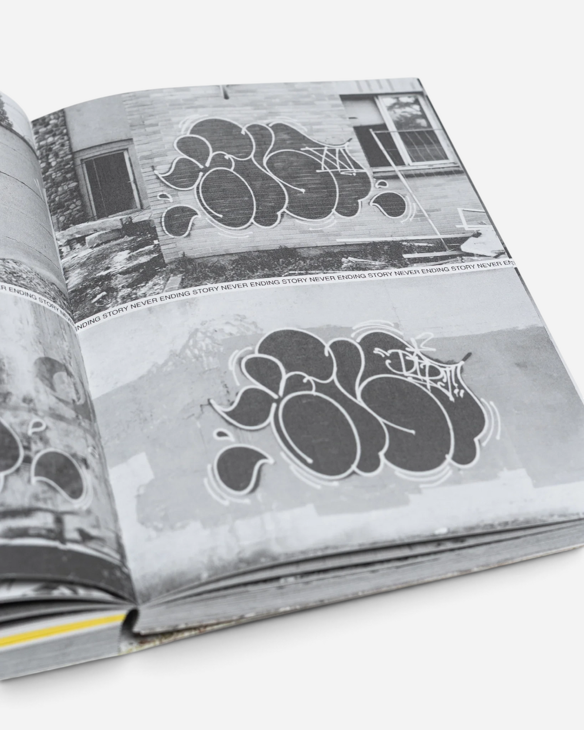 Astrofat Tilt Never Ending Story book open to pages showing black and white graffiti throw-up photography